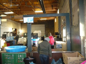 A roomy space with kiosks sporting plastic wading pool "sorting tubs" at Leduc Bottle Depot