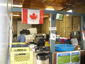 A Canadian flag brightens a sorting station at Leduc Bottle Depot